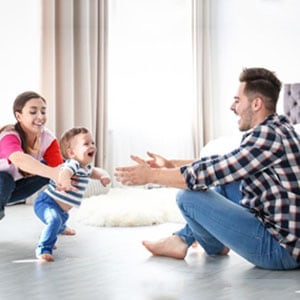 A happy family bonding with their baby in the comfort of their living room